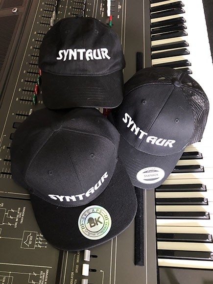 Black caps with monogrammed SYNTAUR logo