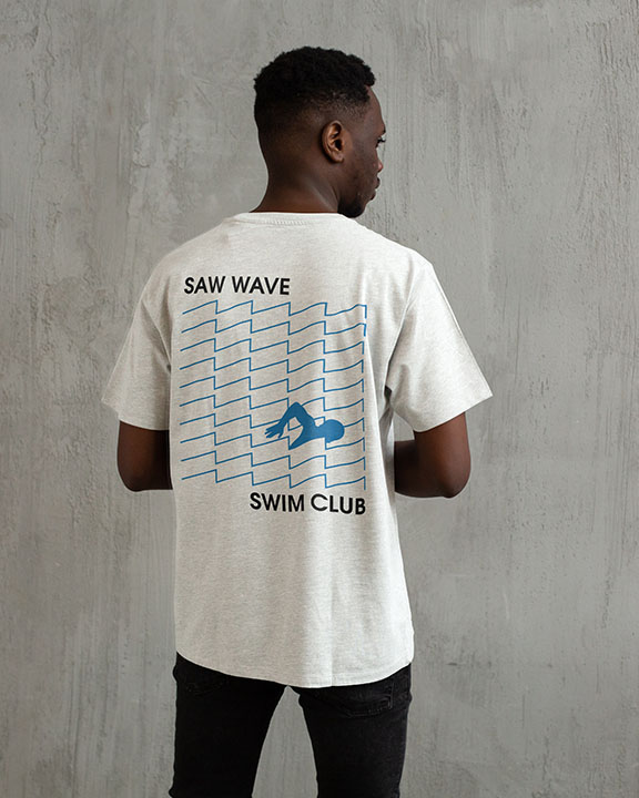 Back of white short-sleeve shirt with Syntaur Saw Wave Swim Club logo