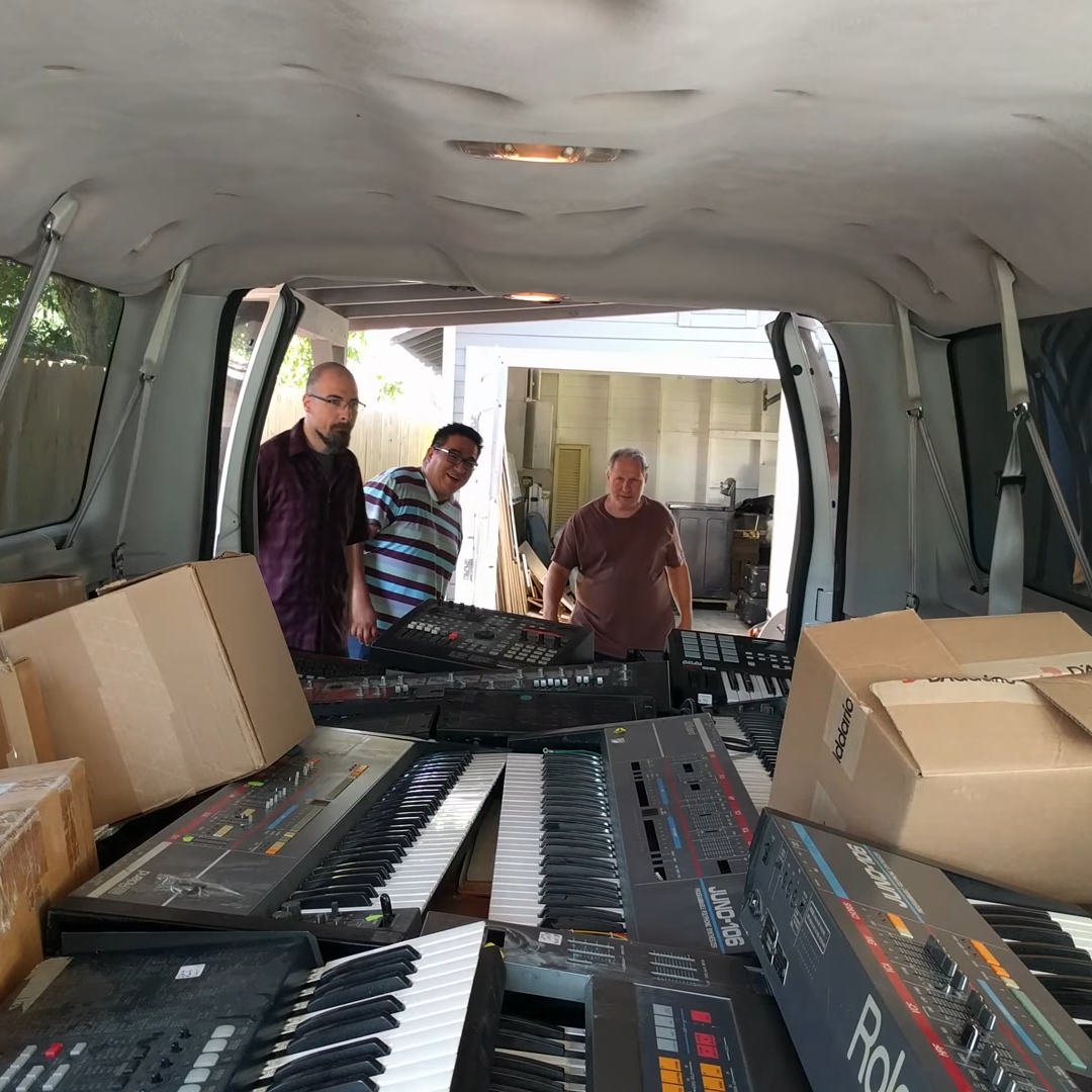 Cliff, Eddie, and Gerald get their first look in the back of a van filled with keyboards.