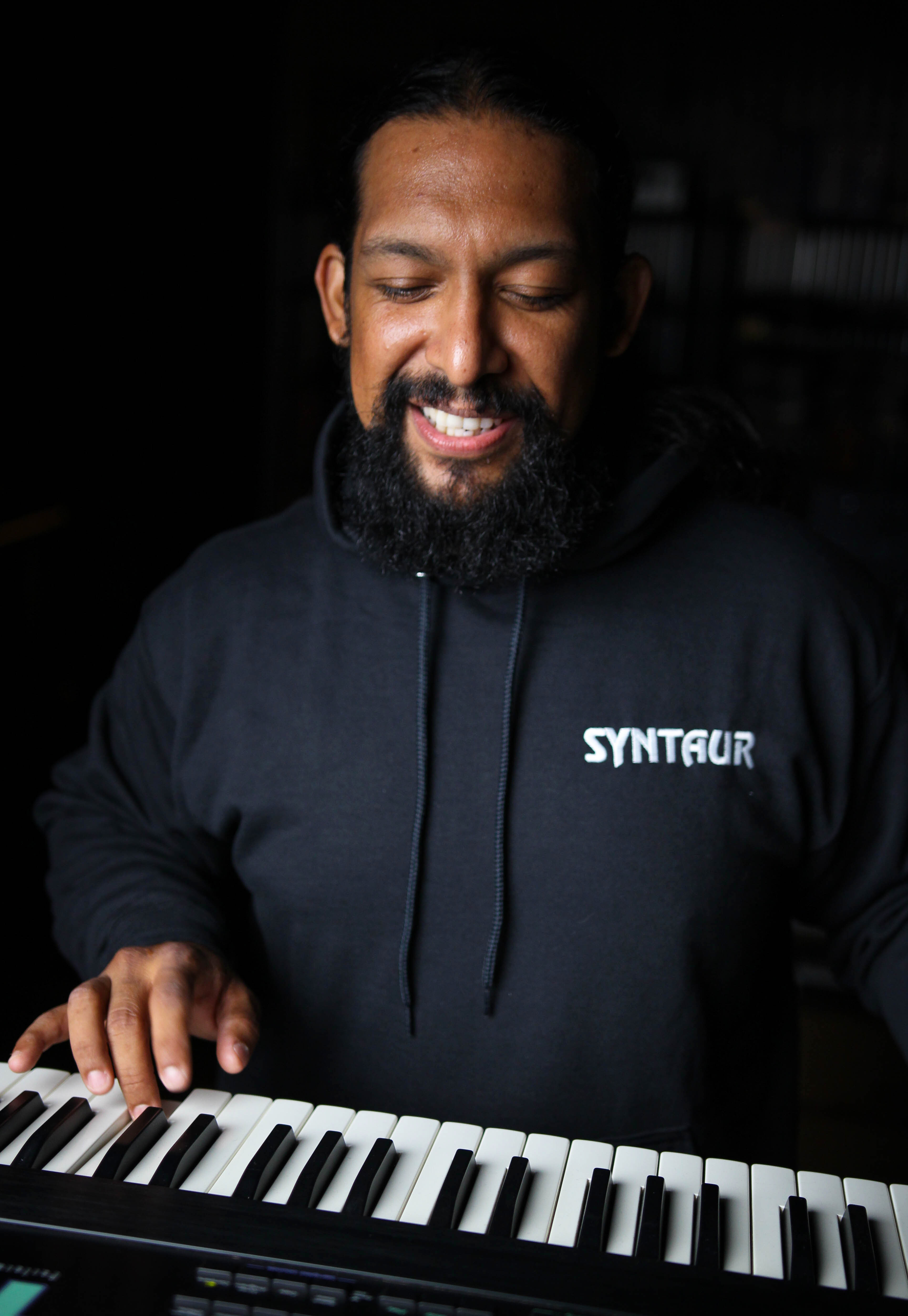Black hoodie with monogrammed SYNTAUR logo